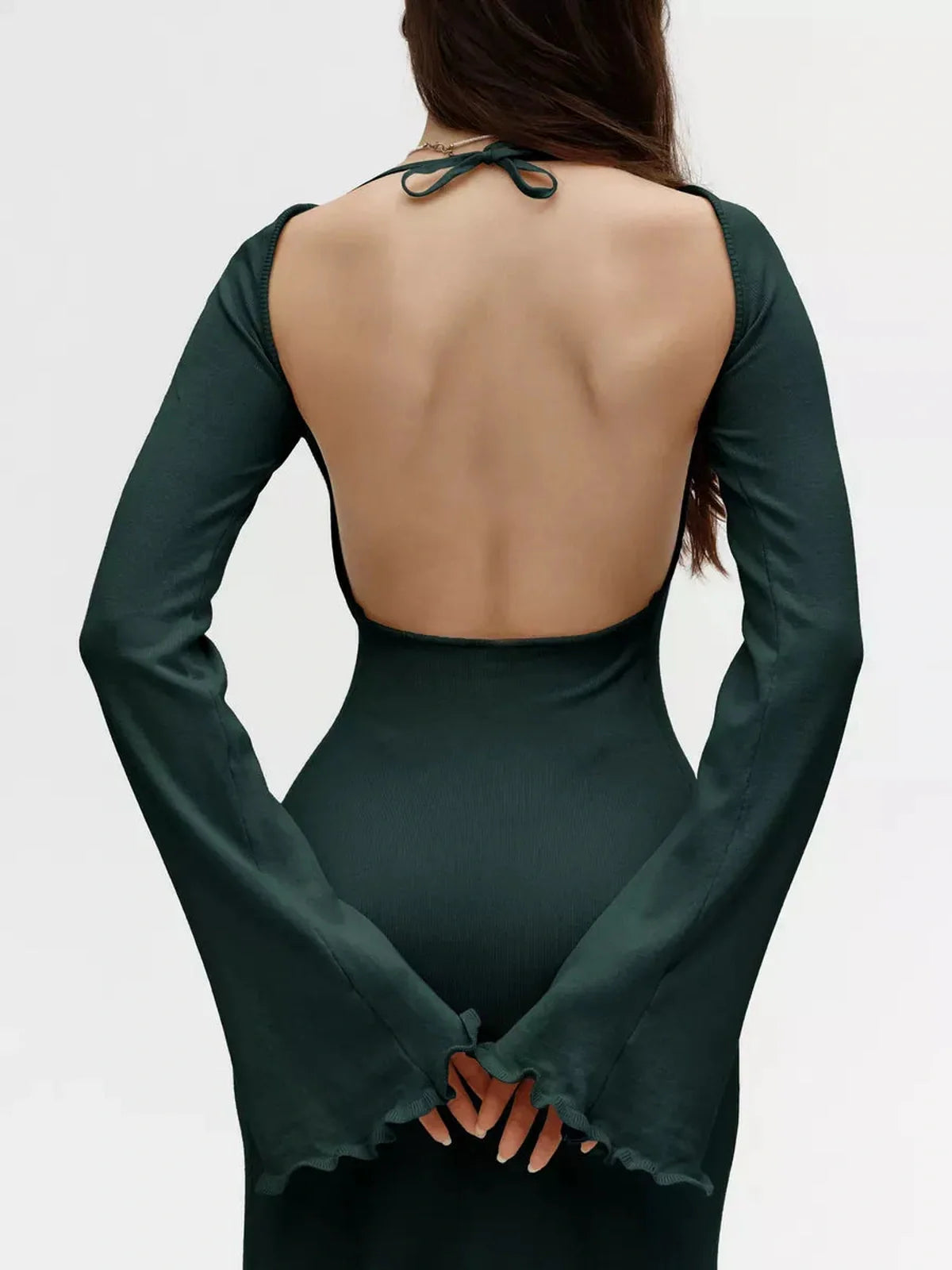 Back view of the Serenity Knit Midi Dress showcasing its open back and flounced sleeves, perfect for wedding guest or formal occasions.