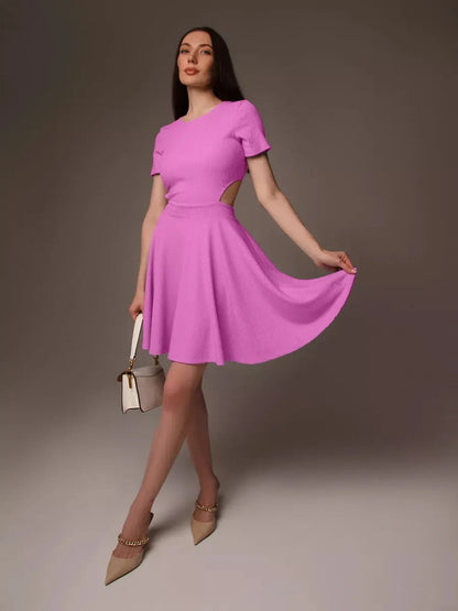 Model showcasing a playful pink Cutout Charm Mini Dress with flared skirt and open waist detail, perfect for summer events.
