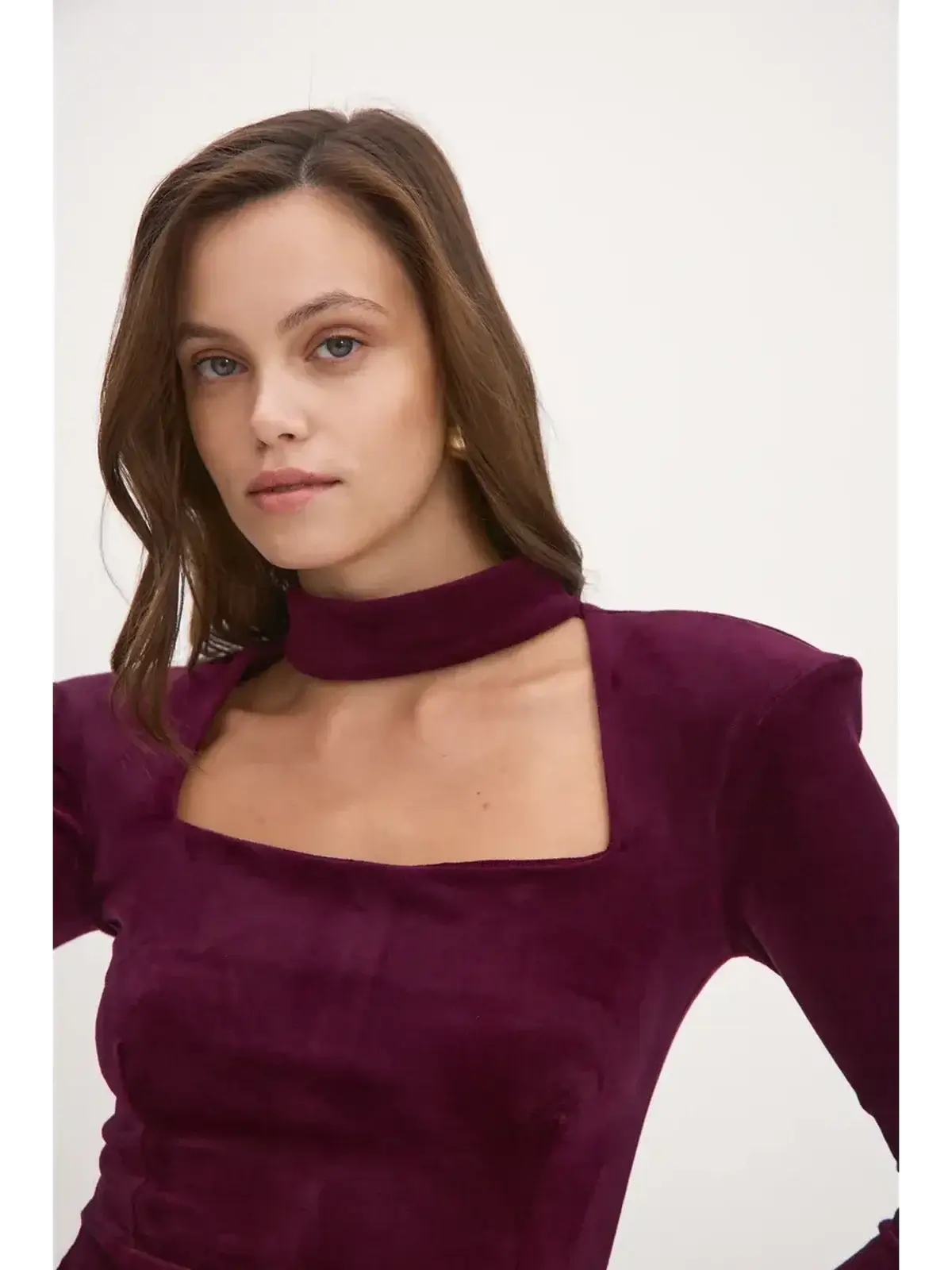 Model wearing the Velvet Aura long sleeve bodycon dress in deep burgundy with choker neckline, perfect for parties.