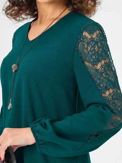 Elegant green mini dress with lace sleeve detailing, perfect for summer parties or formal occasions.