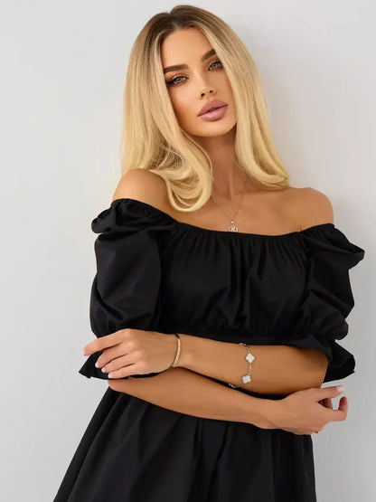 Elegant woman in a black off-shoulder mini dress with puff sleeves, perfect for summer and formal occasions.