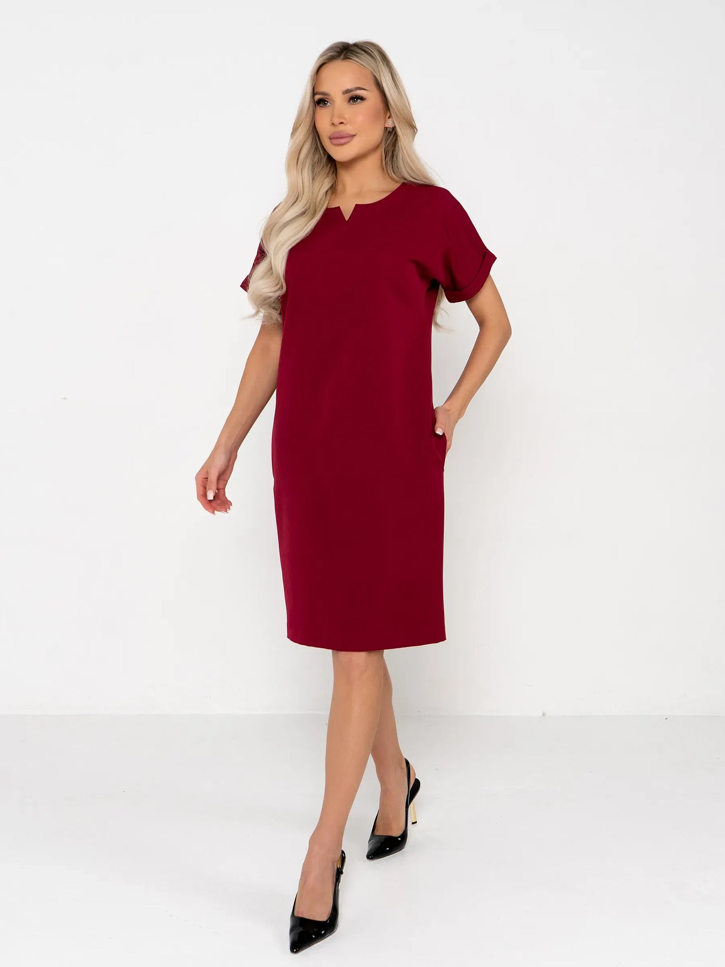 Model wearing a crimson mini dress featuring a structured silhouette and notched neckline, ideal for weddings and formal occasions.