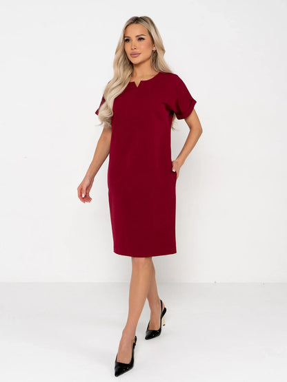 Model wearing a crimson mini dress featuring a structured silhouette and notched neckline, ideal for weddings and formal occasions.