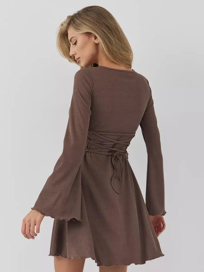 Back view of a women’s brown mini dress featuring flared sleeves and a figure-defining tie waist, perfect for summer occasions.