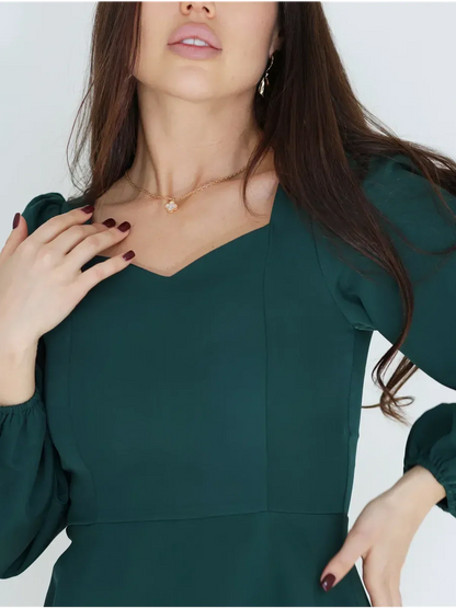 Emerald Grace mini dress featuring a sculpted bodice and elegant puff sleeves, perfect for wedding guest and formal occasions.