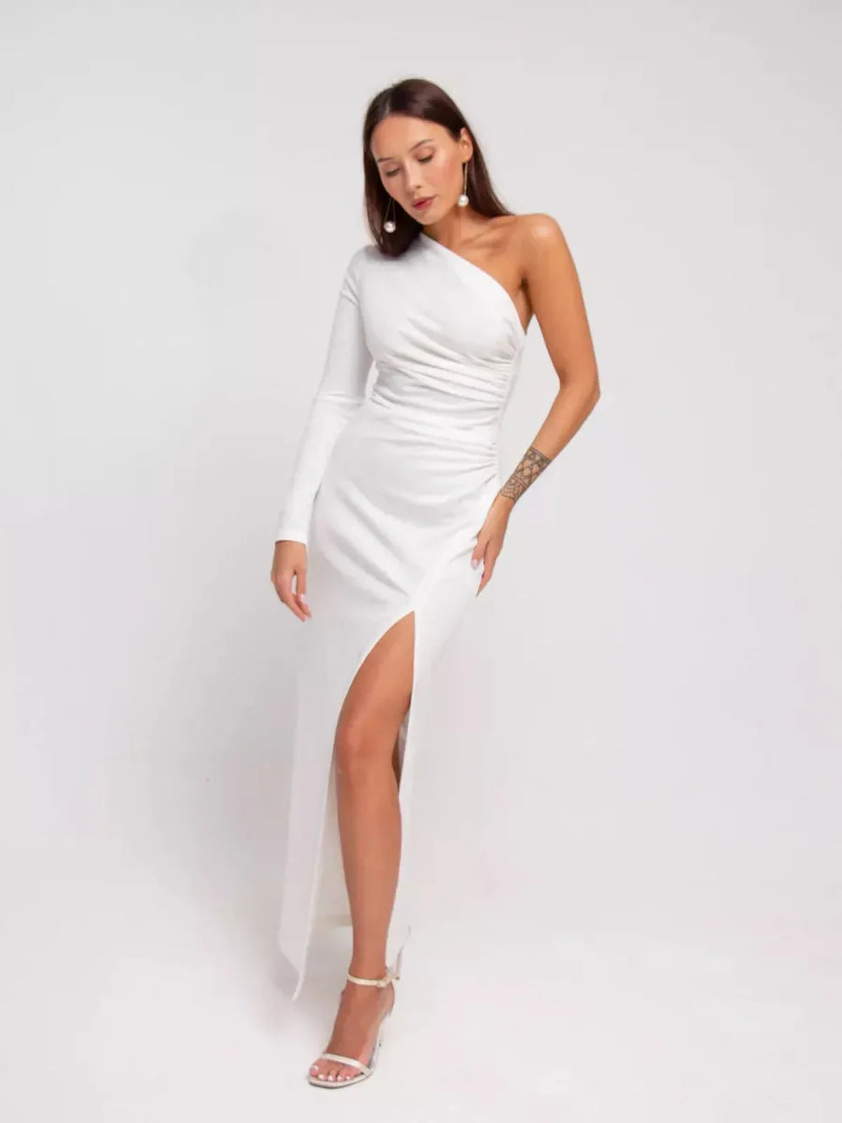 Elegant one-shoulder Celeste Maxi Dress in white with draped details and high side slit for formal occasions.