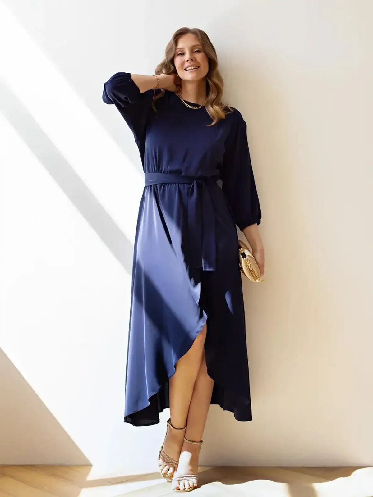 Model showcases the elegant Noir Grace Midi Dress in navy, featuring a flowing silhouette and stylish side slit.