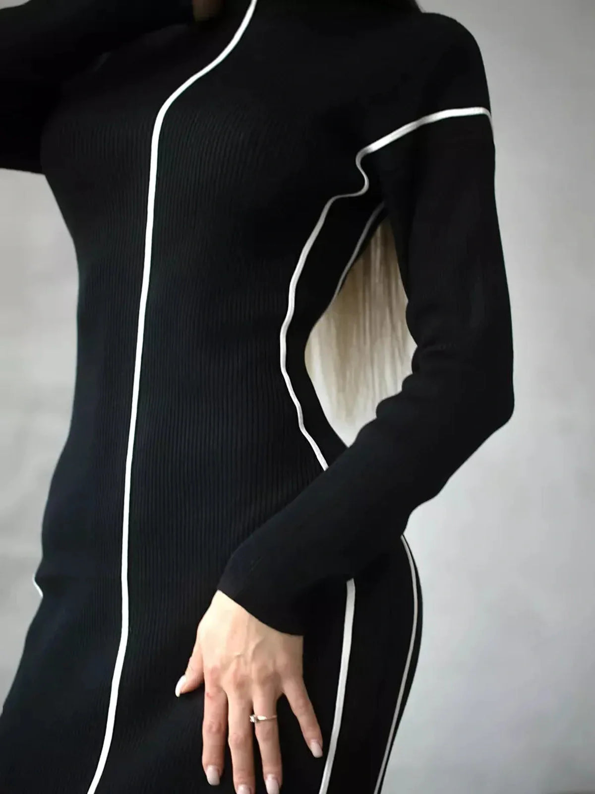 Sculpted Line Midi Dress in black with white contrast stripes, highlighting a figure-flattering silhouette perfect for various occasions.