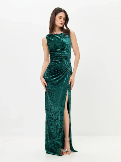 Elegant Velvet Aura Maxi Dress in green with high slit and ruching, perfect for weddings and formal events.