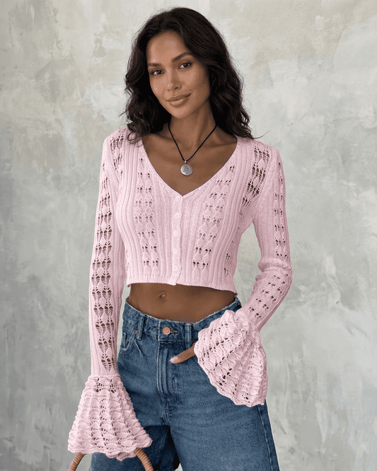 Woman wearing a pink Blossom Cardigan with flare sleeves and V-neckline by Slimona.
