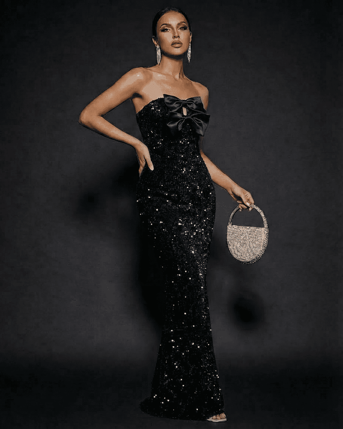 Elegant model in Noir Maxi Dress by Slimona, a strapless sequin evening gown with satin bows.