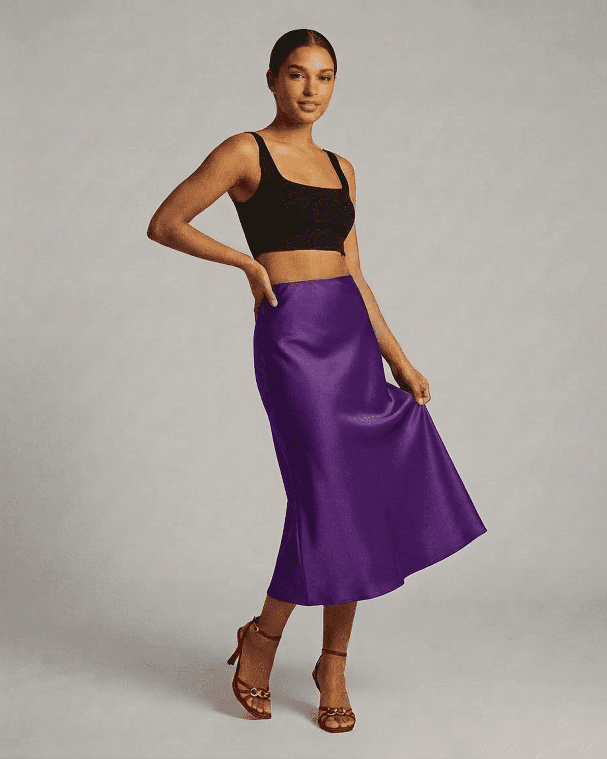 Model wearing the Amethyst Midi Skirt by Slimona, showcasing the elegant satin mermaid design in vibrant purple.