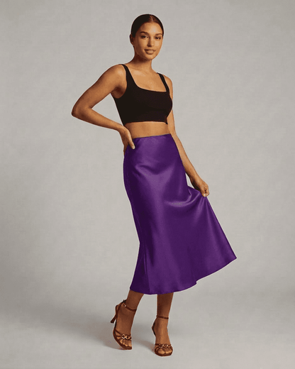 Model wearing the Amethyst Midi Skirt by Slimona, showcasing the elegant satin mermaid design in vibrant purple.