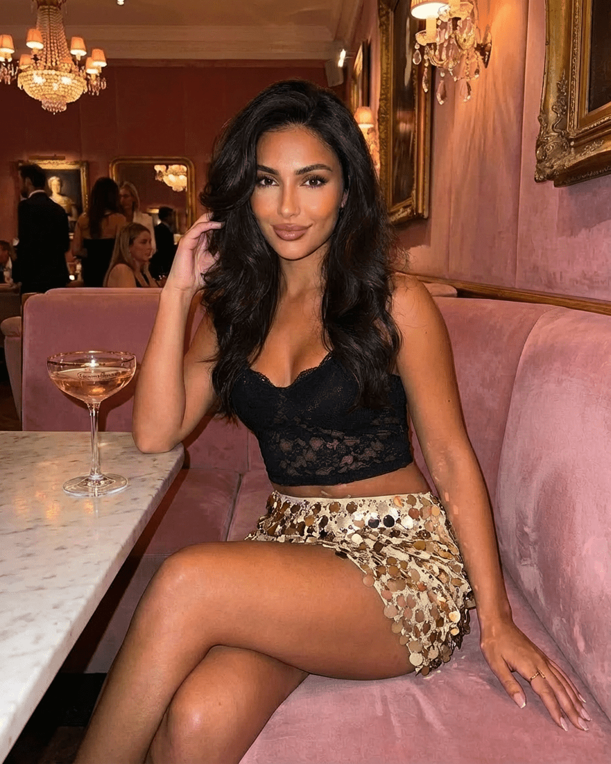 Aurelia Mini Skirt styled with a black top, showcasing gold sequin details in a chic setting by Slimona.