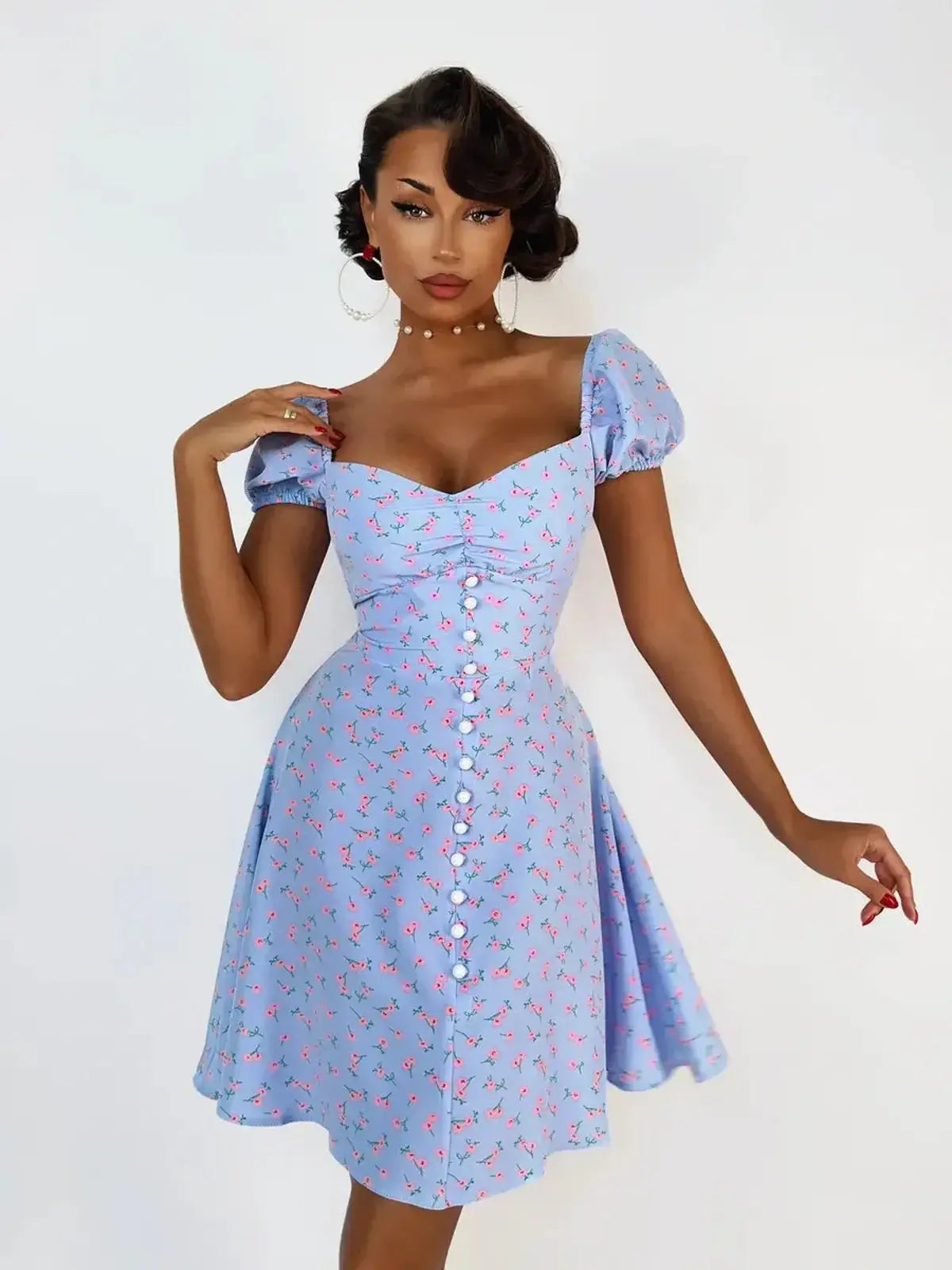 Baby blue Rose Petal Mini Dress with pink florals, sweetheart neckline, and button details, perfect for summer parties.