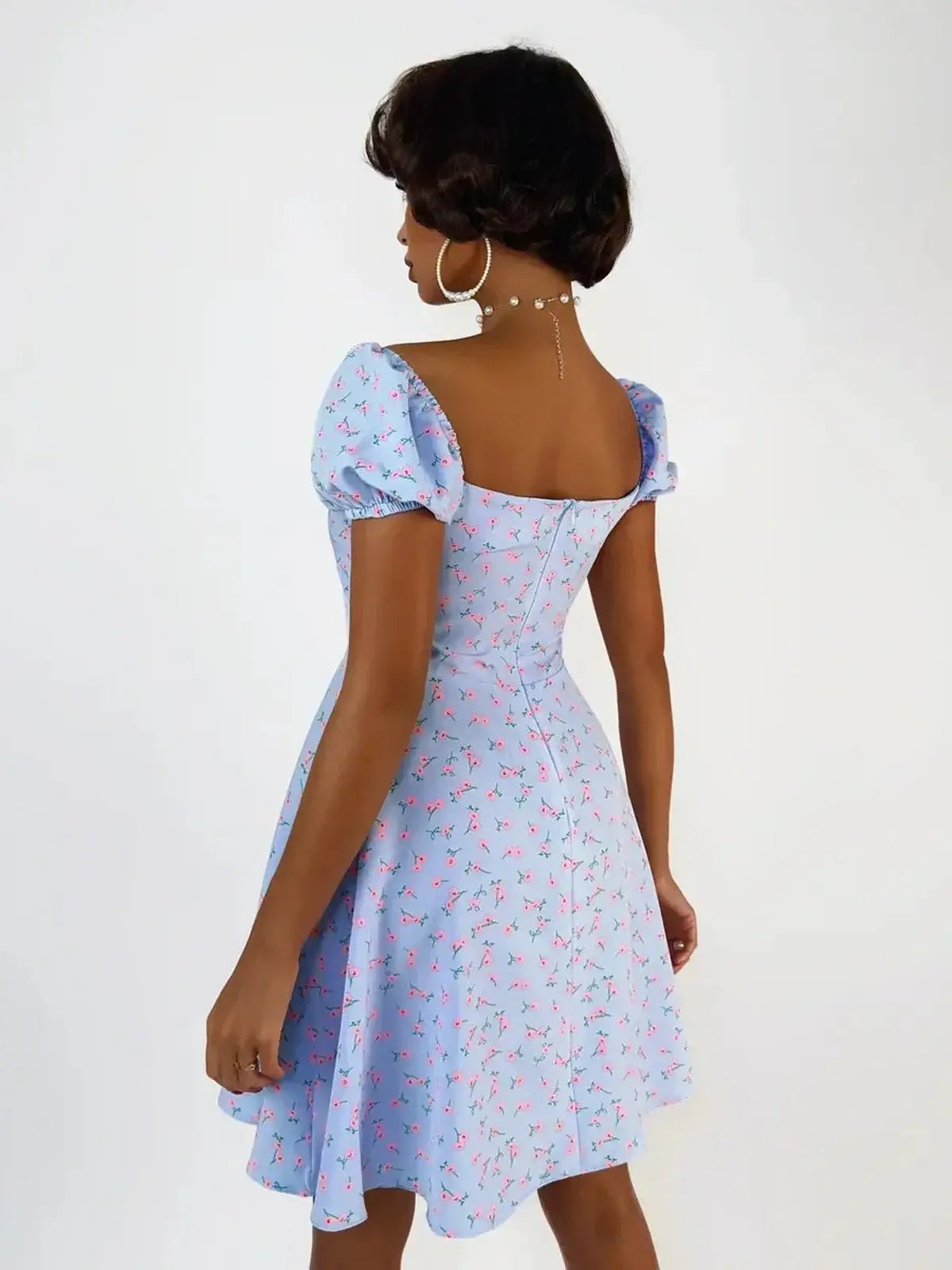 Baby blue Rose Petal Mini Dress with pink florals, featuring a flattering fit-and-flare silhouette and puff sleeves.