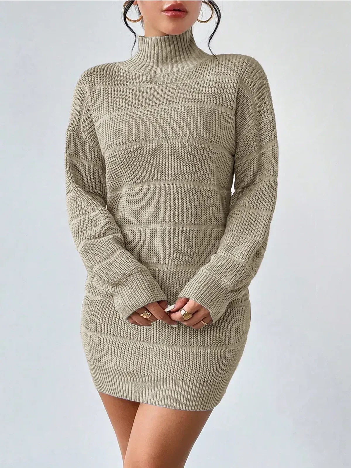 Beige knit mini dress with long sleeves and a mock neck, perfect for cool-weather styling and modern occasions.