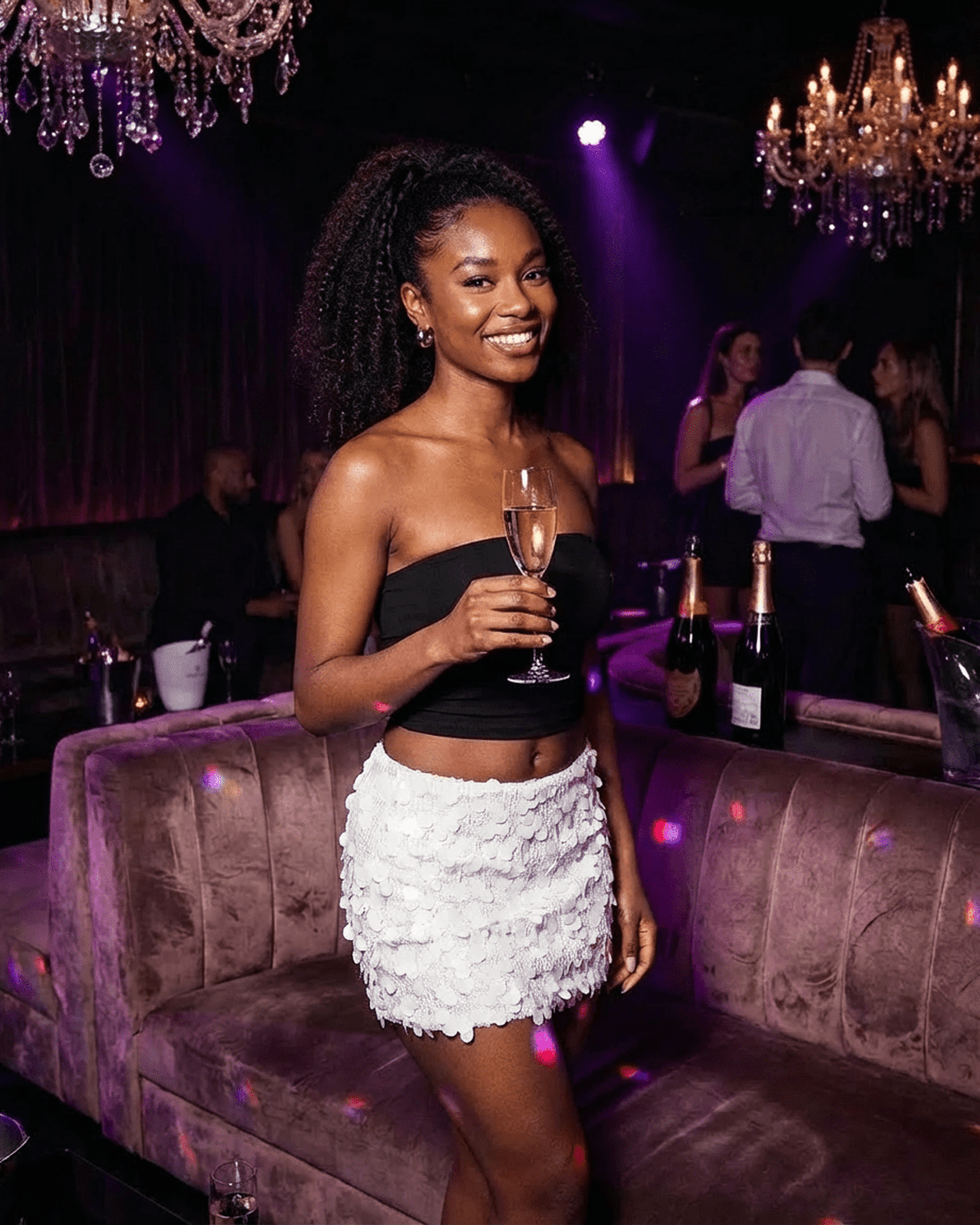 Bianca Mini Skirt by Slimona, white sequin A-line bodycon mini skirt worn at a glamorous party.