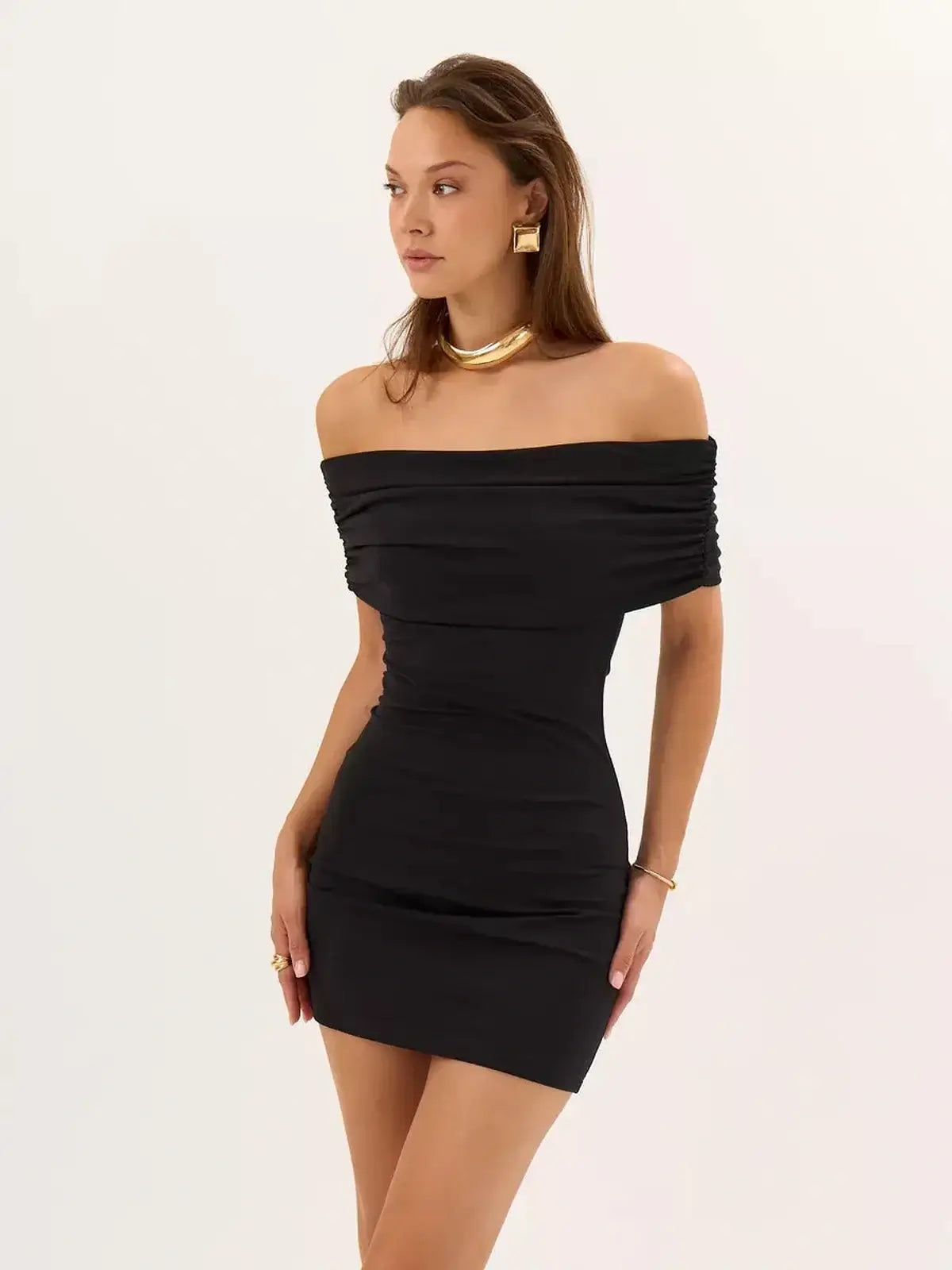 Black bodycon mini dress with off-the-shoulder neckline and ruched detailing, perfect for summer or evening events.