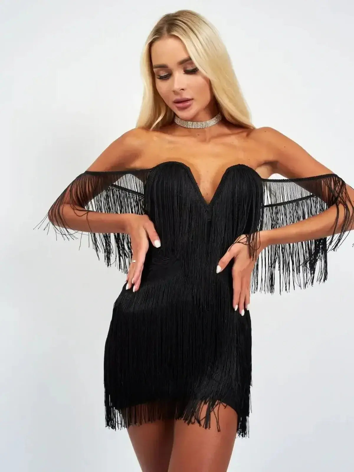 Fringe Icon black mini dress with off-shoulder design and cascading fringe, perfect for party and cocktail occasions.