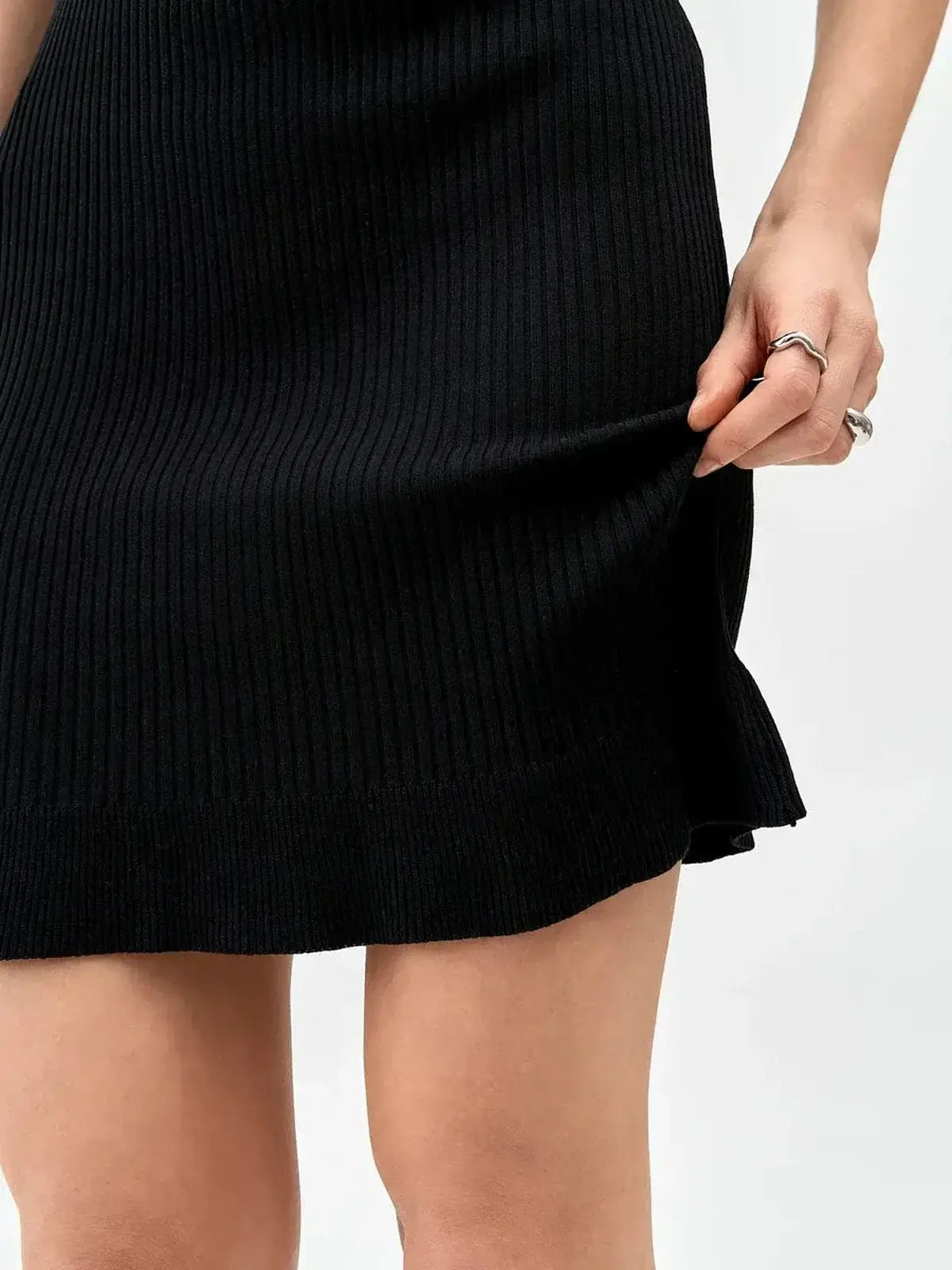 Black ribbed mini dress showcasing a fitted design, perfect for summer dresses and cocktail occasions.