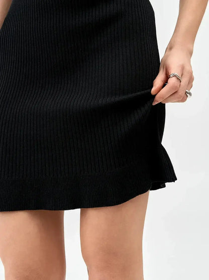 Black ribbed mini dress showcasing a fitted design, perfect for summer dresses and cocktail occasions.