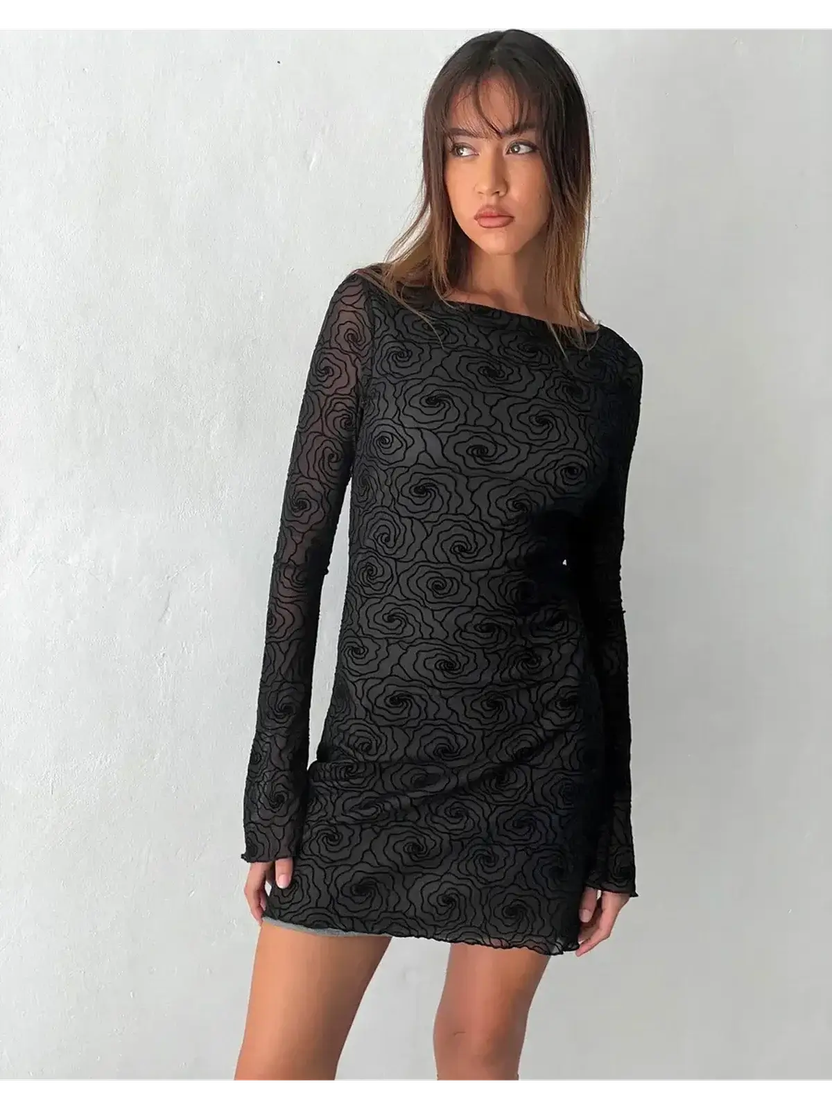 Black mini dress with long sleeves and floral design, perfect for cocktail parties and evening events.