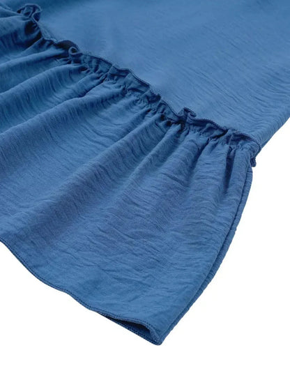 Close-up of the ruffled hem of the Blue Mirage Mini Dress in blue, showcasing lightweight fabric and feminine design.