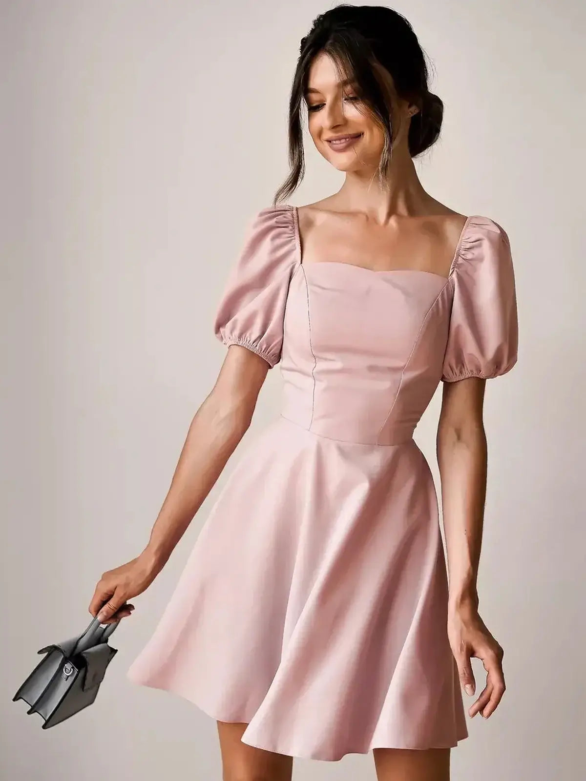Light pink mini dress with puff sleeves and square neckline, perfect for summer parties and special occasions.