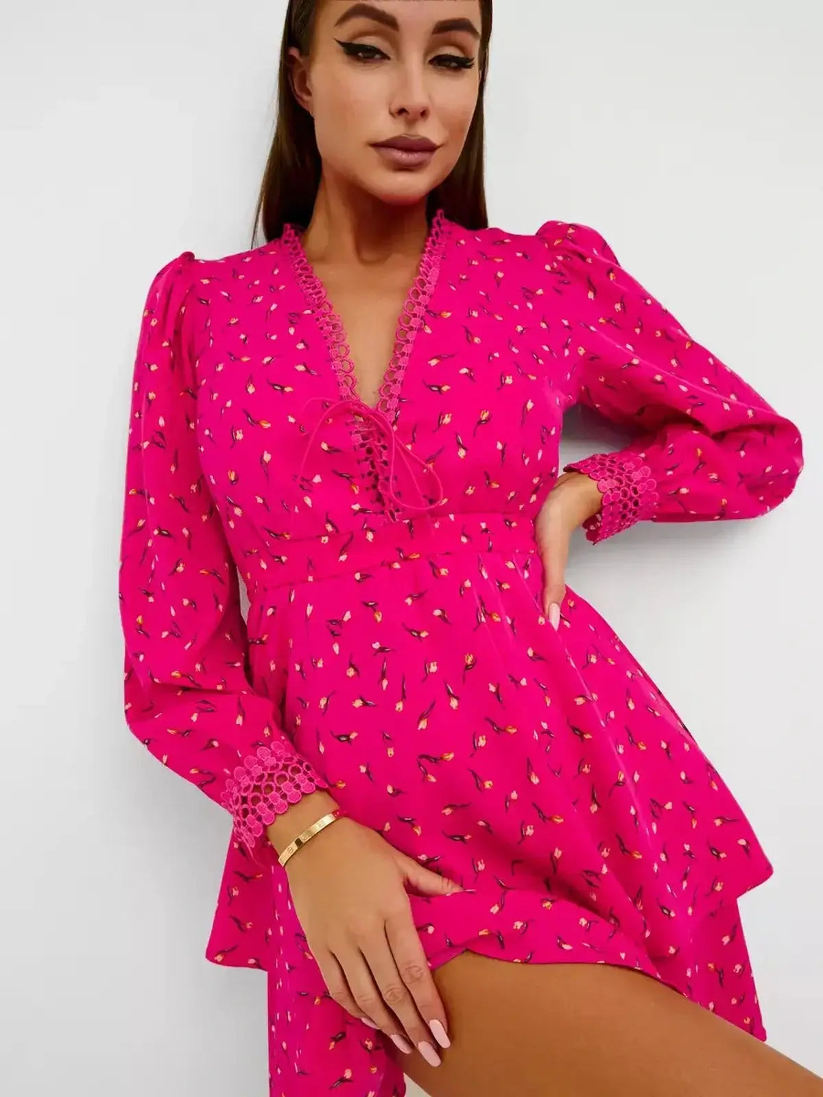 Bright pink Tulip Bloom mini dress with floral print, lace trim, and puff sleeves, perfect for summer events.