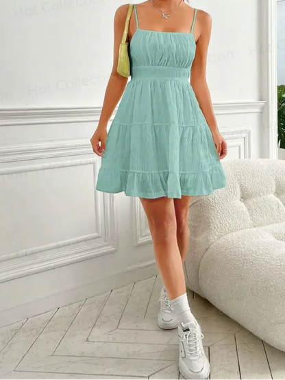 Light mint tiered mini dress with strappy design, perfect for summer days and casual outings.