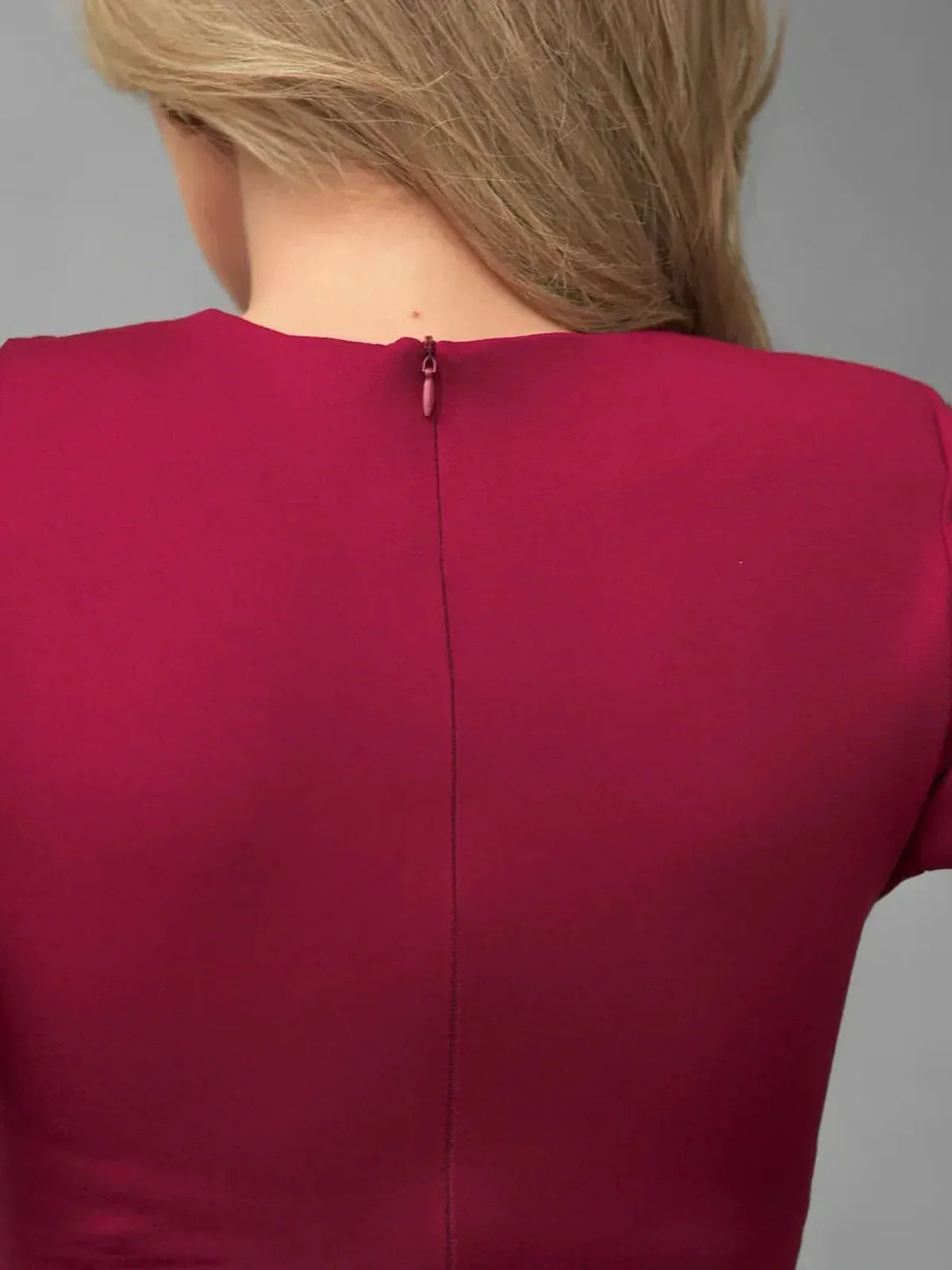 Back view of the Burgundy Grace mini dress showcasing the elegant neckline and zipper detail.