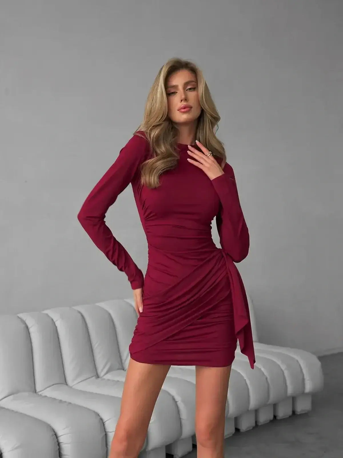 Burgundy Grace bodycon mini dress with ruching and tied waist sash, perfect for evening and formal occasions.