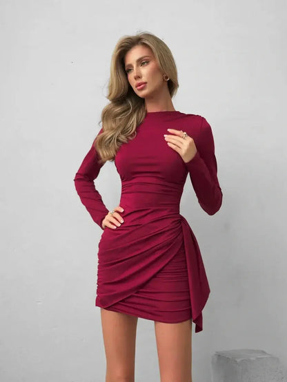 Burgundy Grace mini dress featuring bodycon silhouette, elegant ruching, and sophisticated tied waist sash.
