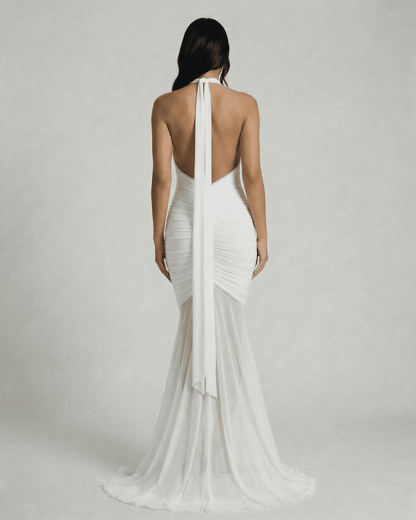 Back view of Slimona Ivory Maxi Dress, showcasing the elegant ruched design and flowing fabric.