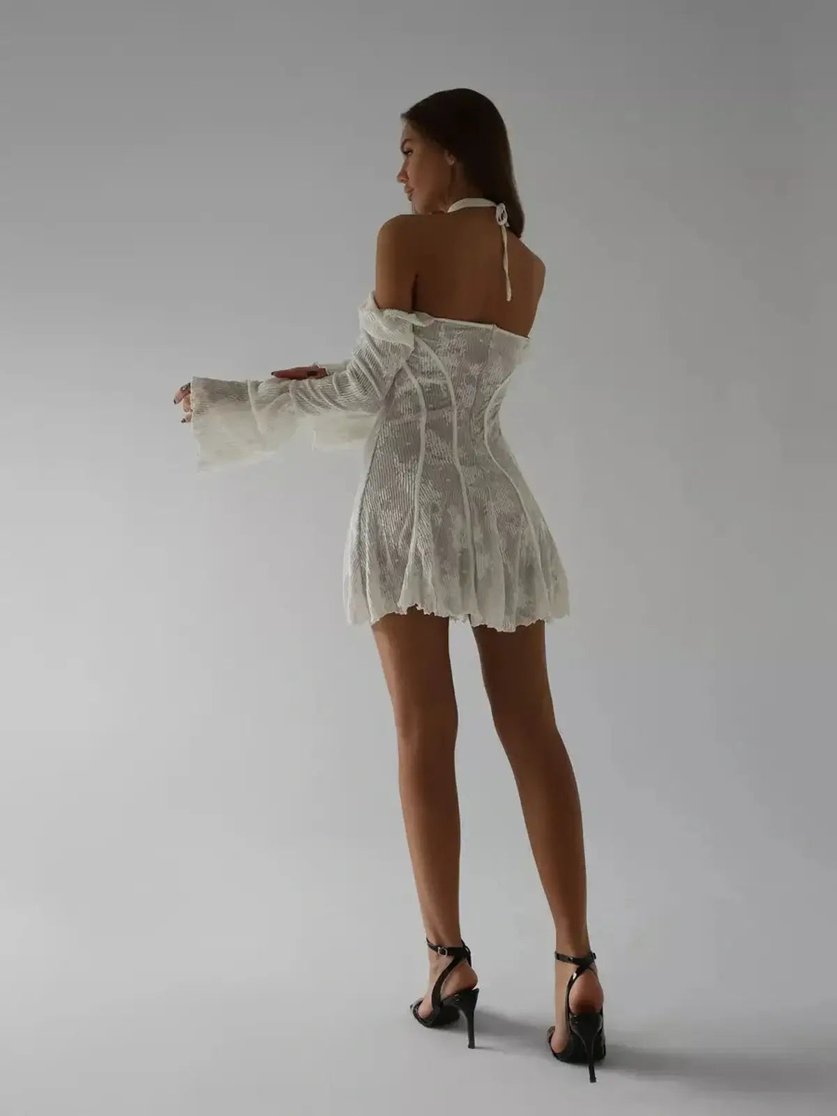 Elegant white lace mini dress with off-the-shoulder sleeves, perfect for weddings and summer parties.