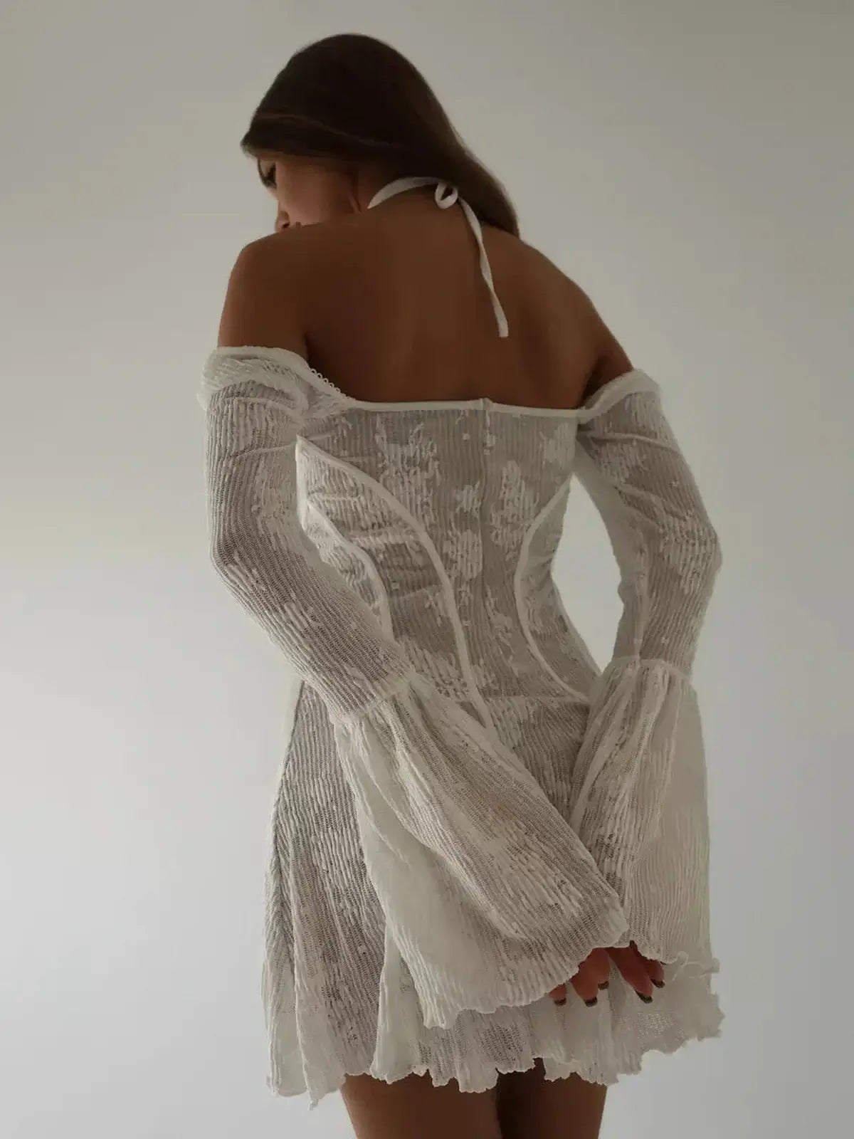 White Celeste Lace mini dress with off-the-shoulder bell sleeves and corset bodice, perfect for summer weddings.