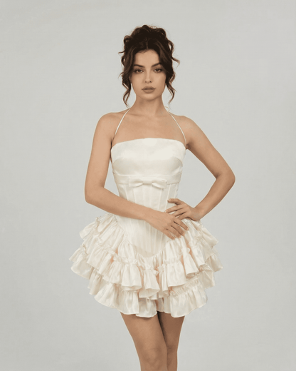 Celeste Mini Dress by Slimona featuring a corset-inspired design in soft white with tiered ruffles.