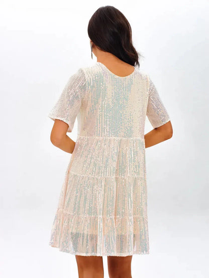 Back view of a shimmering white mini dress with tiered ruffles and short sleeves, perfect for wedding guest or summer parties.