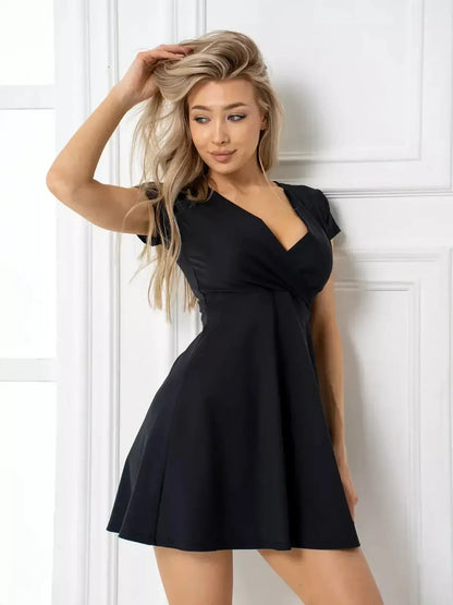 Model wearing the Charm Curve Mini Dress, a chic black dress with a V-neckline and flared skirt, perfect for summer or cocktail events.