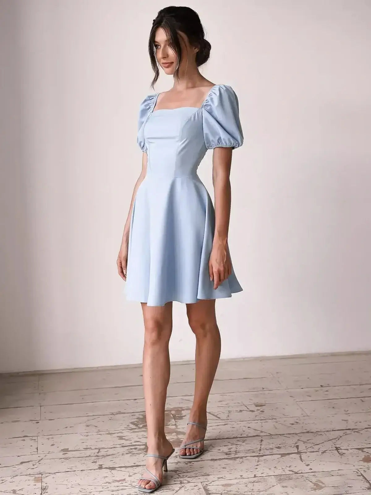 Light blue Cloud Belle mini dress with puff sleeves and square neckline, ideal for summer events and weddings.