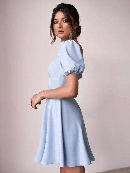 Elegant light blue mini dress with puff sleeves, perfect for summer weddings, parties, or casual outings.