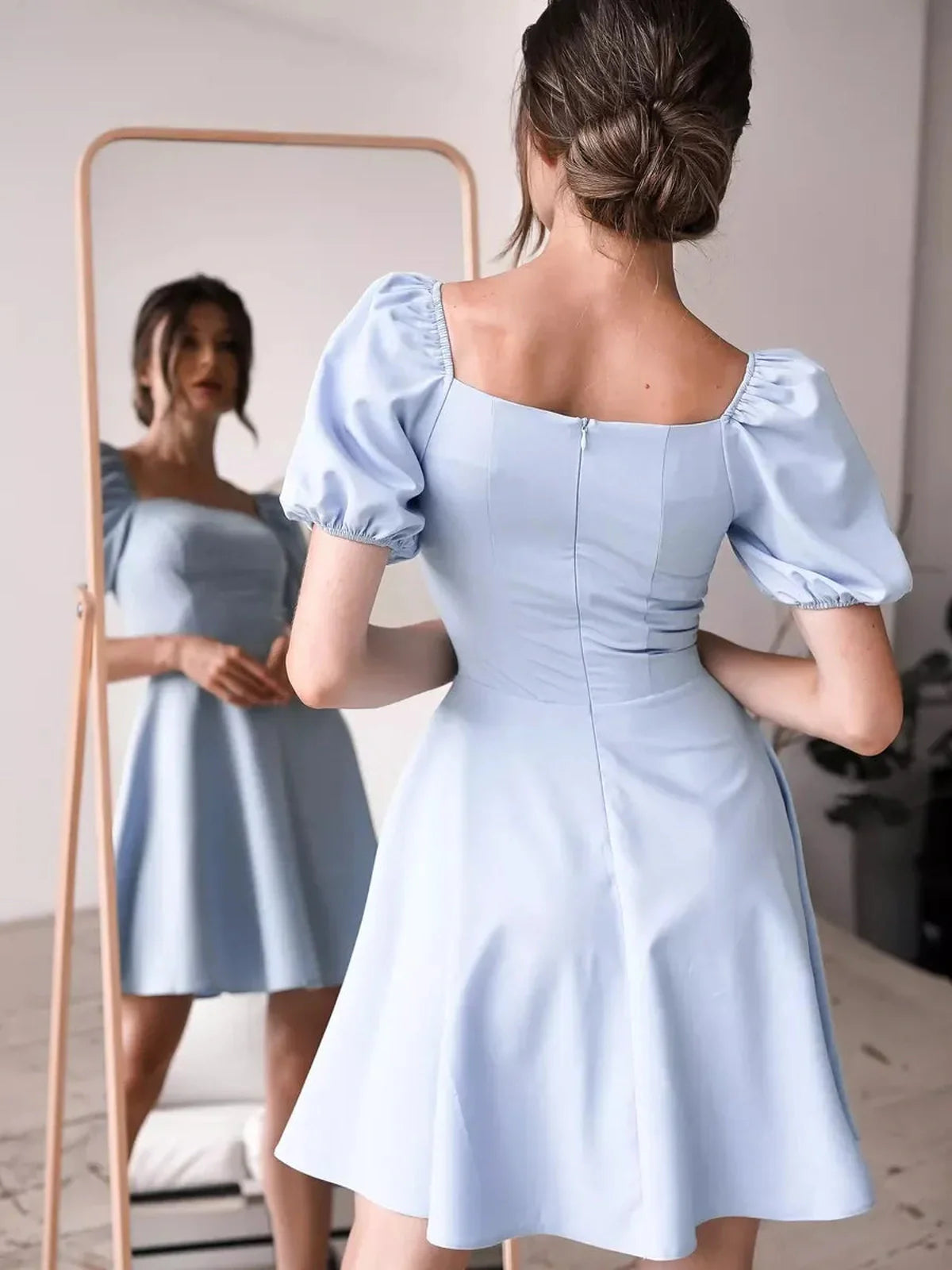 Elegant light blue mini dress with puff sleeves and a square neckline, perfect for summer or wedding guest attire.