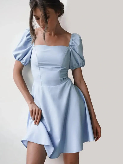 Light blue mini dress with puff sleeves and square neckline, perfect for summer weddings or cocktail parties.