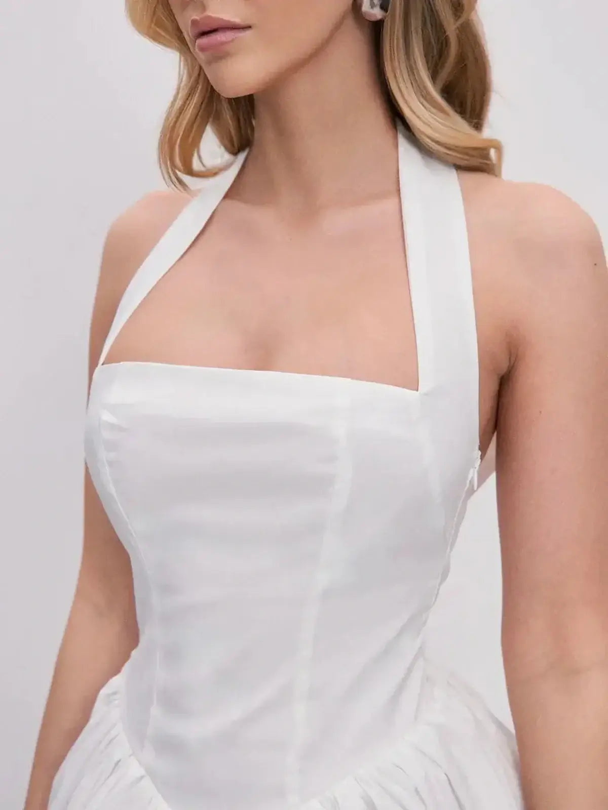 Close-up of the Cloud Belle white dress featuring a halter neckline and structured corset bodice.