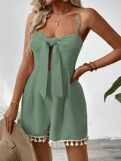 Coastal Bloom Mini Dress in green with front tie bow and tassel hem, perfect for summer occasions and casual outings.