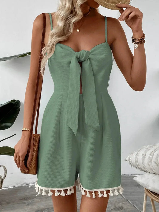 Coastal Bloom Mini Dress in sage green with front-tie bow and tassel hem, perfect for summer occasions and casual outings.