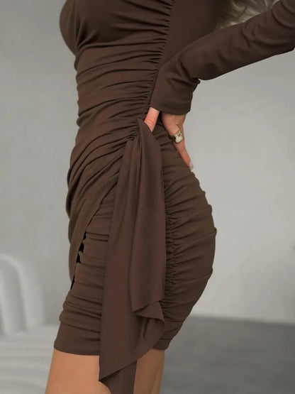 Side view of the Cocoa Drape mini dress featuring strategic ruching and a tie detail for a flattering silhouette.