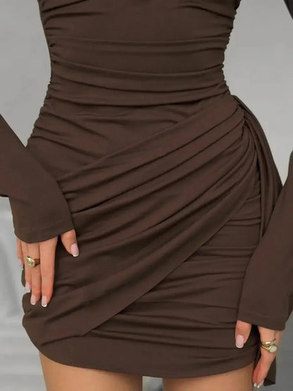 Cocoa Drape mini dress with soft ruching, long sleeves, and elegant draping for a flattering bodycon fit.