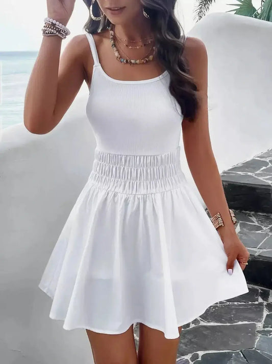 White mini dress with ribbed bodice and flowy skirt, perfect for summer and beach outings.